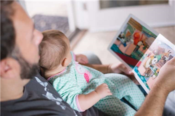 father reads to baby