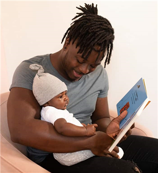 man reading to baby